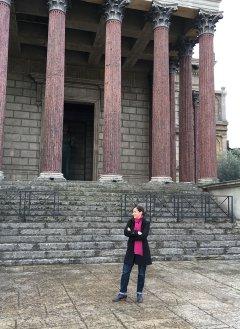 an image of michelle berenfeld standing in front of architectural columns